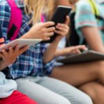 close up of elementary students with tablet pc
