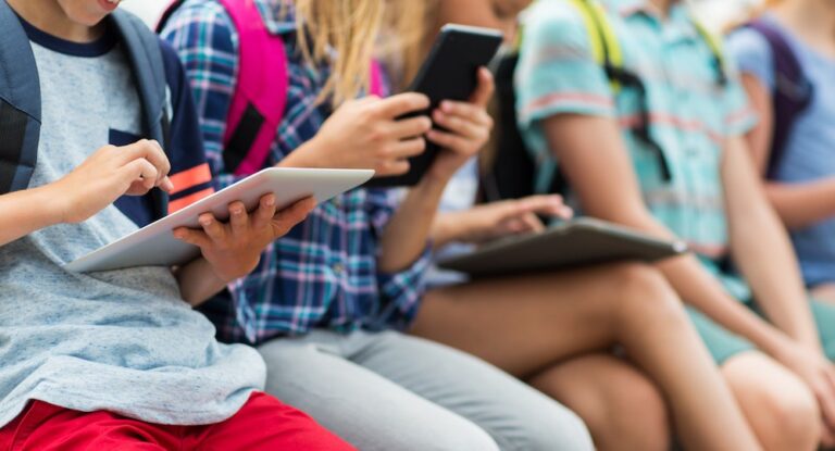 close up of elementary students with tablet pc